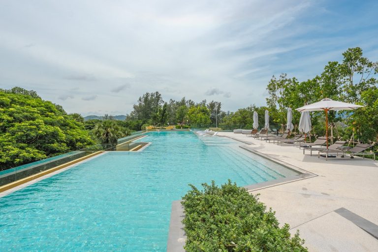 Luxury 1-bedroom foreign freehold condo for sale at Laguna Beachside Phuket with modern open-plan living room.